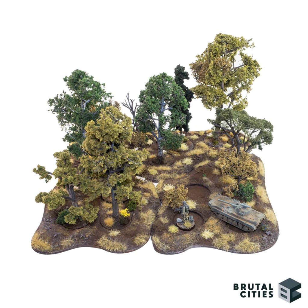 MDF terrain base with woodland scenics tree armatures and foliage. Forest with miniatures for scale.